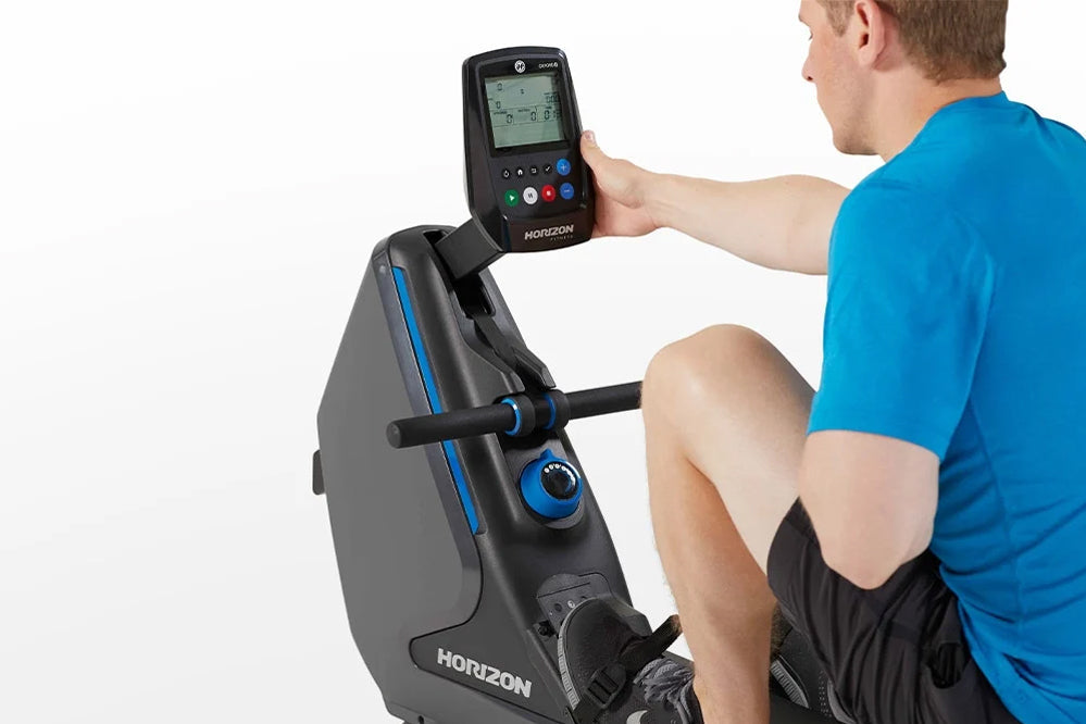 Man in blue shirt using Horizon Oxford 3 rowing machine with digital display console, gray and black machine with blue accent
