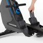 Horizon Oxford 3 rowing machine with gray and black frame, blue accents, and digital display, shown with model using foot ped