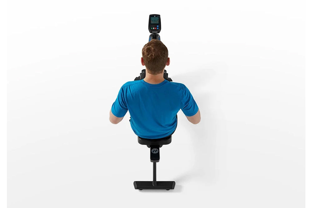 Man wearing blue t-shirt using black Horizon Oxford 3 rowing machine, viewed from behind on white background