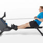 Man in blue shirt using Horizon Oxford 3 rowing machine with black seat and gray frame on white background