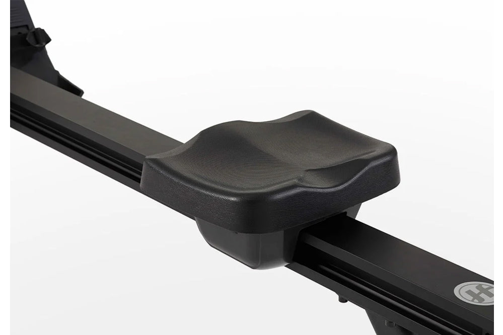 Black contoured seat with textured surface on Horizon Oxford 3 rowing machine frame, on white background