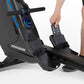 Horizon Oxford 6 rowing machine with black frame and blue accents, shown with person's legs and feet on pedals