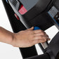 Hand adjusting blue incline button on black Horizon T101 folding treadmill with numbered controls