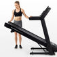 Black folding treadmill with digital display, worn by model in black sports bra and gray shorts on white background