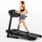 Woman in black sports bra and gray shorts running on black Horizon T101 folding treadmill against white background