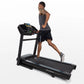 Man running on black Horizon T202 folding treadmill with digital display, wearing gray tank top and black shorts