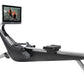 Hydrow Origin rowing machine with black seat and silver frame, featuring mounted tablet display showing workout video, on whi