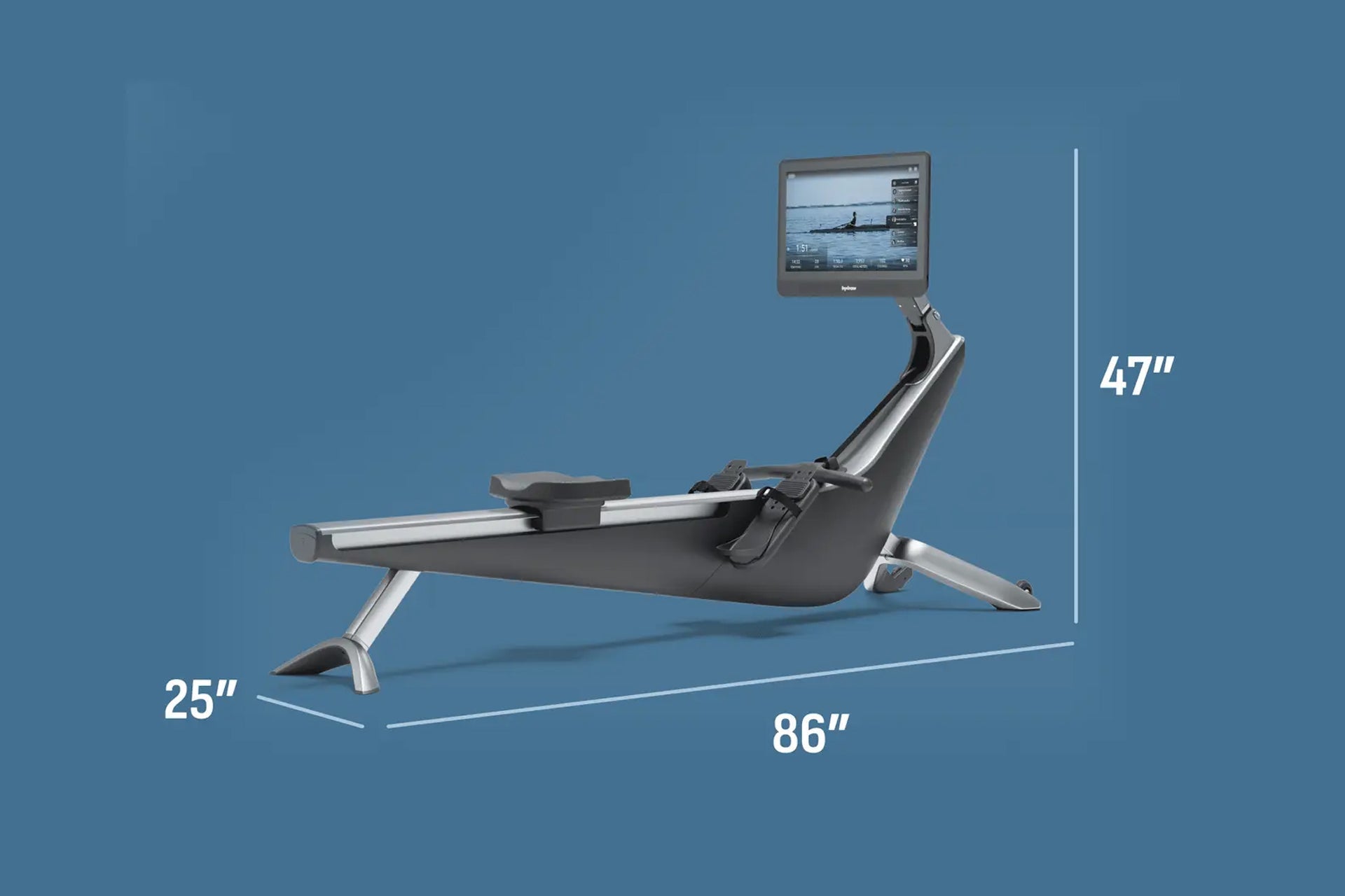 Hydrow Origin rowing machine with black seat and silver frame, equipped with tablet display showing workout video, on blue ba