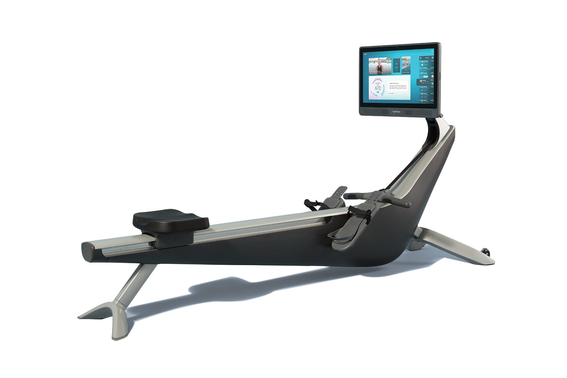 Hydrow Origin rowing machine with black and silver frame, adjustable seat, foot pedals, and mounted touchscreen display showi