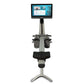 Hydrow Origin rowing machine with gray frame, black seat and footplates, dual handles, and mounted digital touchscreen displa