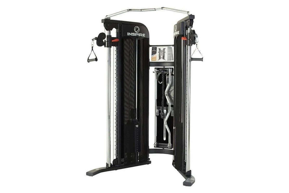 Inspire Fitness FT1 Functional Trainer with dual weight stacks, black frame, silver uprights, and cable attachments on white 