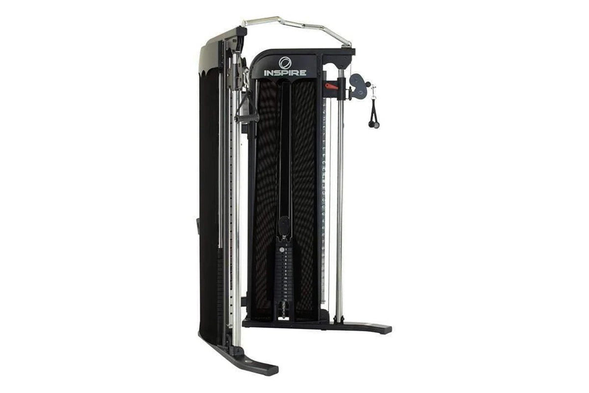 Inspire Fitness FT1 functional trainer with black mesh panels, silver metal frame, and dual cable pulley system on white back