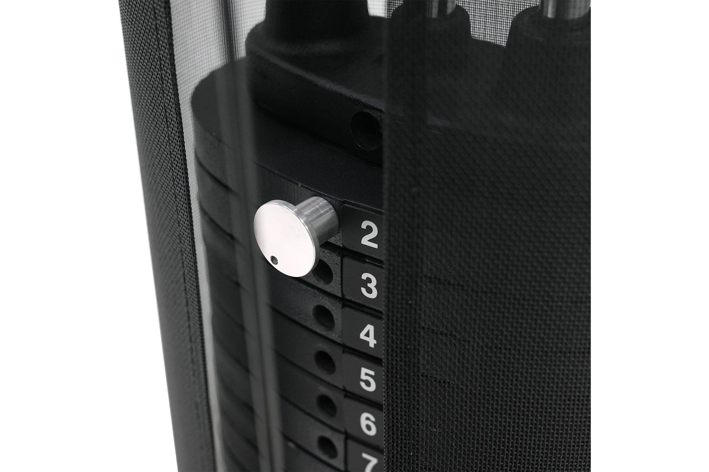 Black multi-gym system with white circular knob and numbered selector buttons 2-7, detail view on white background
