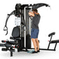 Black multi-station home gym with man demonstrating upper body exercise, featuring adjustable weight stack, leg press platfor