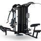 Black multi-station gym system with cable machines, leg press, and seated bench on white background