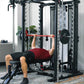 Man performing bench press with red barbell on black and silver Smith cage system in home gym setting