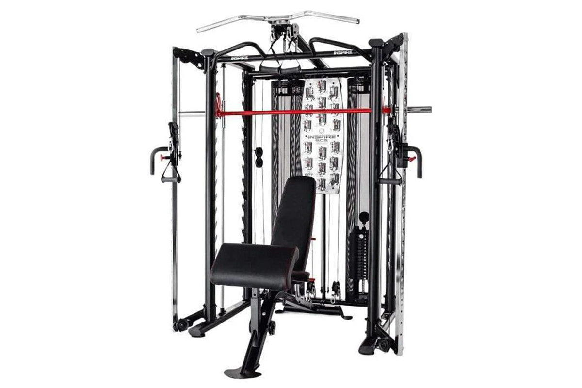 Black and silver multi-functional Smith cage system with cable attachments, red horizontal bar, and black padded bench seat o