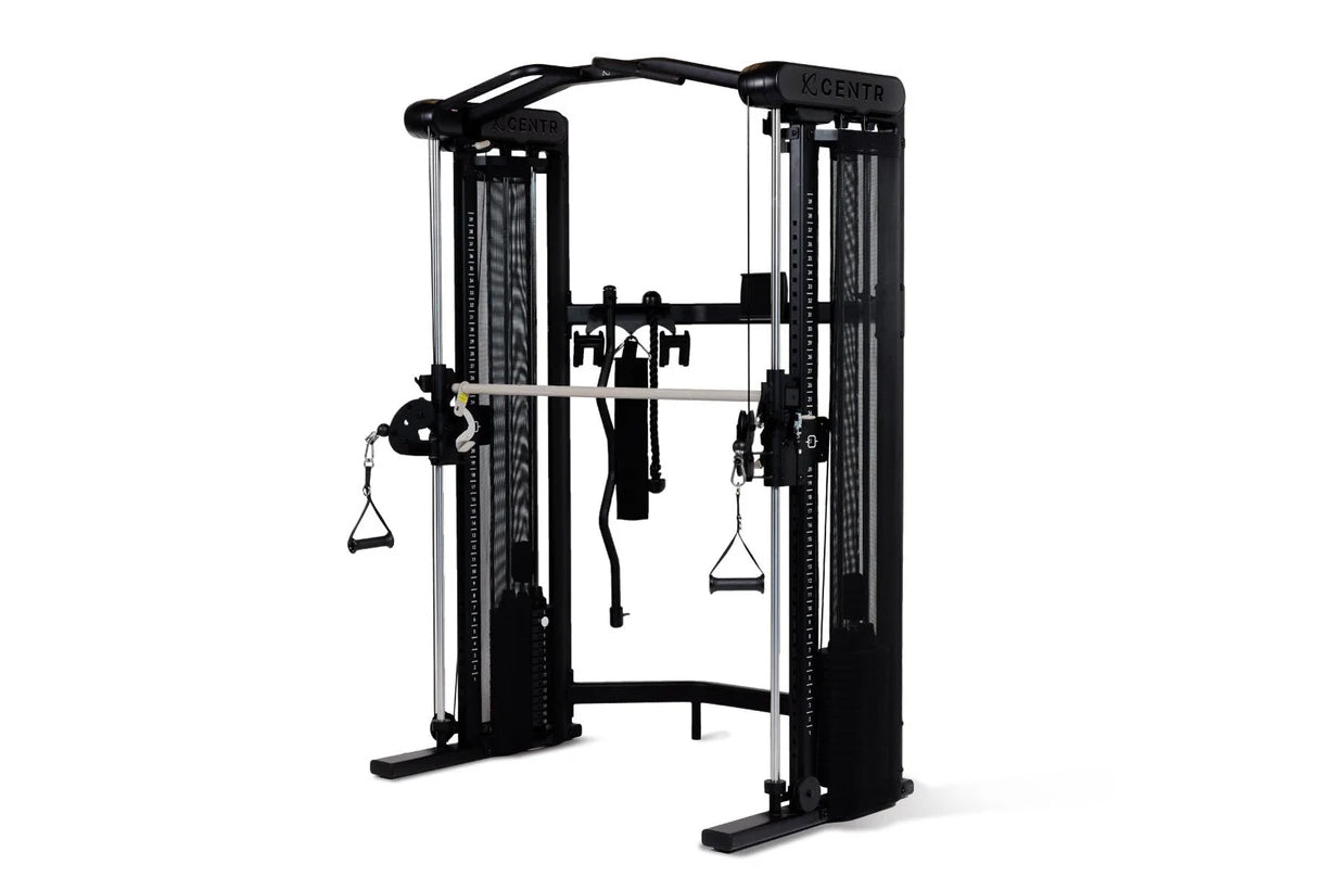 Black and silver functional trainer with dual cable towers, overhead bar, and suspended handles on white background
