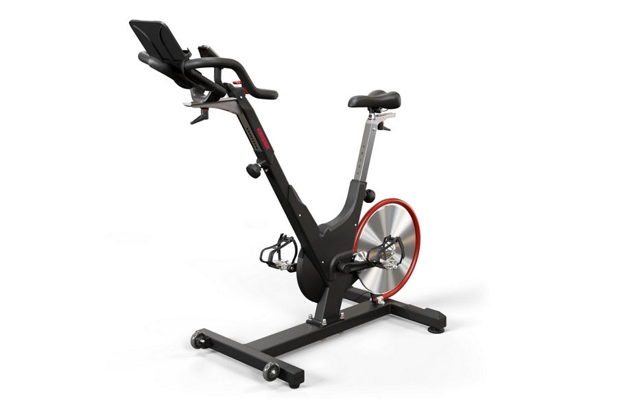 Black and red stationary exercise bike with padded seat, curved handlebars, and red flywheel on white background