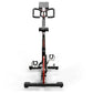 Keiser M3i indoor cycle with red and black frame, black handlebars, padded seat, and digital console on white background