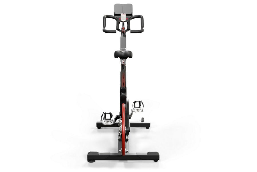 Keiser M3i indoor cycle with red and black frame, black handlebars, padded seat, and digital console on white background
