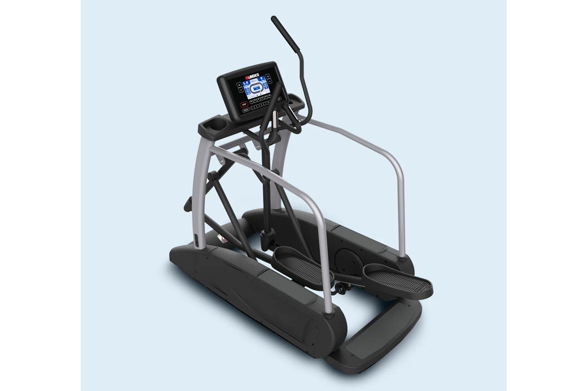 Landice E9 commercial elliptical with black foot pedals, gray frame, digital console, and safety handrails on light blue back