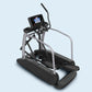 Commercial elliptical machine with black pedals, silver frame, and digital console displaying blue screen on light blue backg