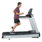 Man running on Landice L10 Club treadmill with digital display, wearing burgundy shirt and black shorts