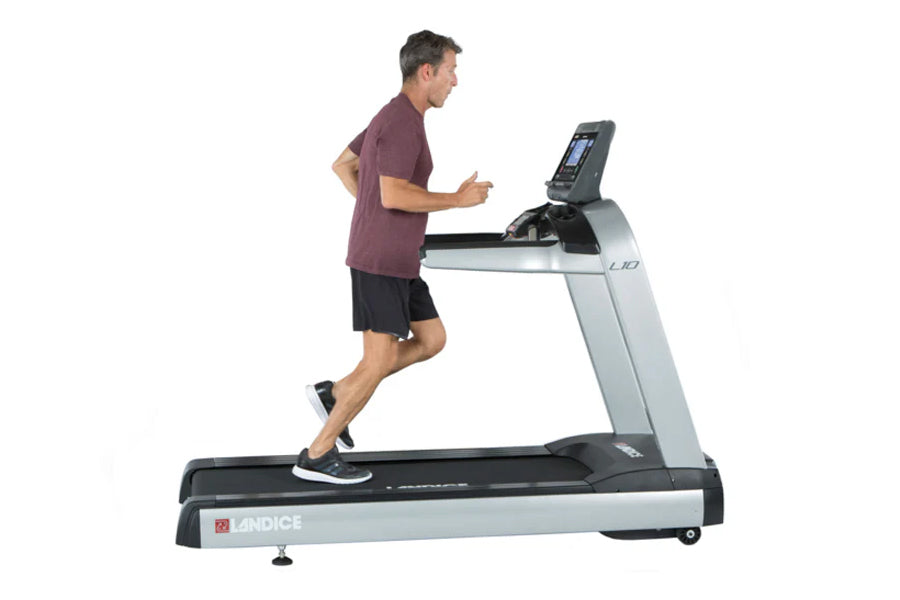 Man running on Landice L10 Club treadmill with digital display, wearing burgundy shirt and black shorts
