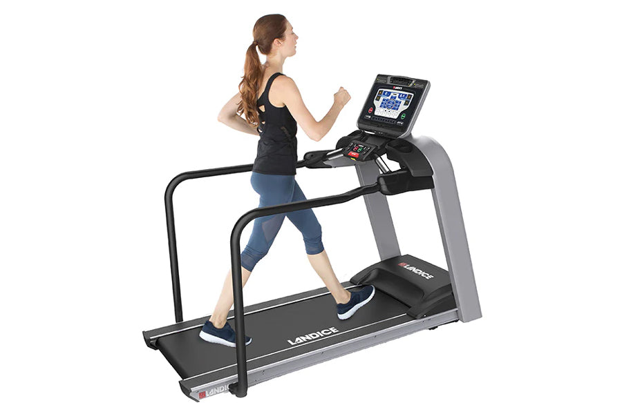 Woman running on Landice L8 treadmill with black frame, gray accents, and digital console display