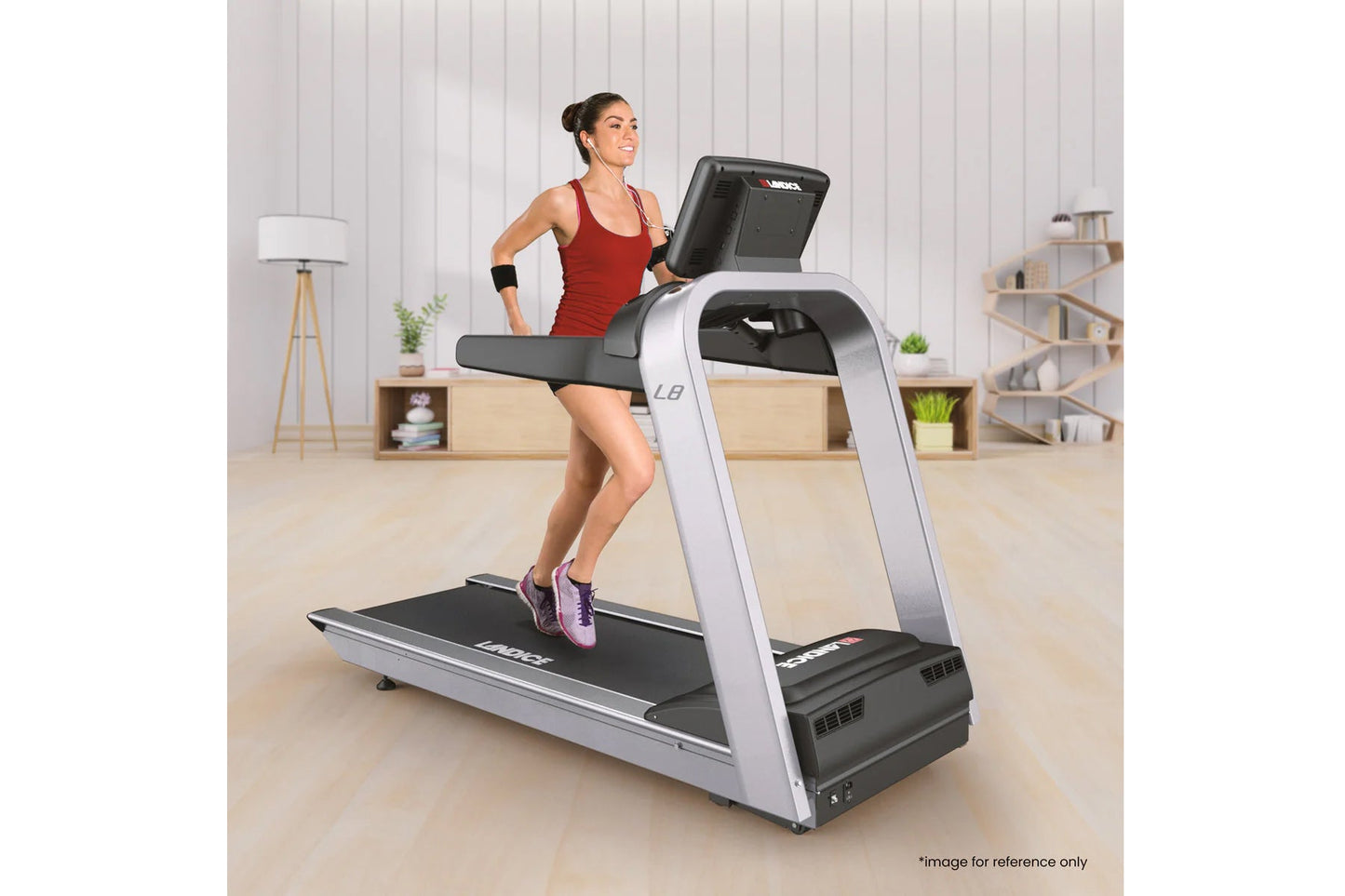 Woman running on silver and black Landice L8 treadmill with digital display in modern home gym