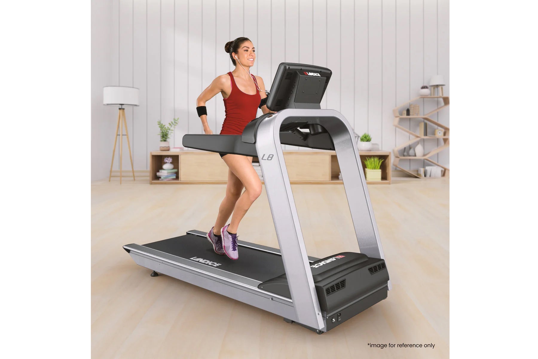 Woman running on silver and black Landice L8 treadmill with digital display in modern home gym