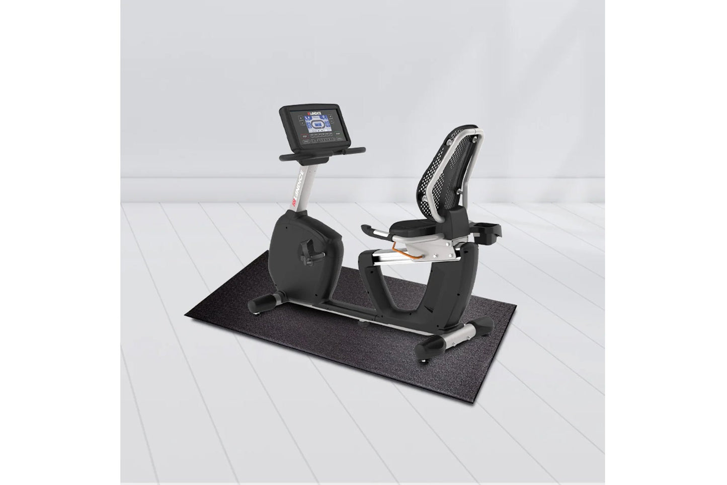 Landice R7 black and silver recumbent exercise bike with digital display console on white mat, shown in white room