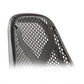 Black mesh backrest with perforated diamond pattern on recumbent exercise bike, close-up detail view on white background
