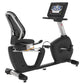 Landice R7 black recumbent exercise bike with digital display console, mesh back seat, and silver frame on white background