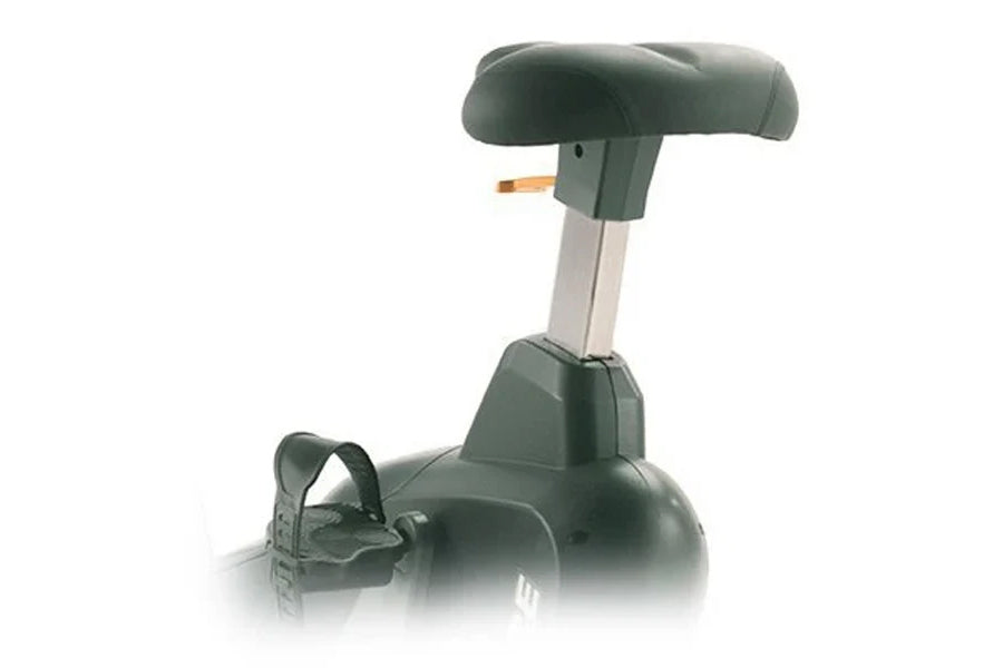 Landice U7 upright exercise bike with dark green seat and base, cream-colored support column, and foot pedals on white backgr