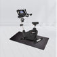 Landice U7 upright exercise bike with black and silver frame, digital display console, and black mat on white floor