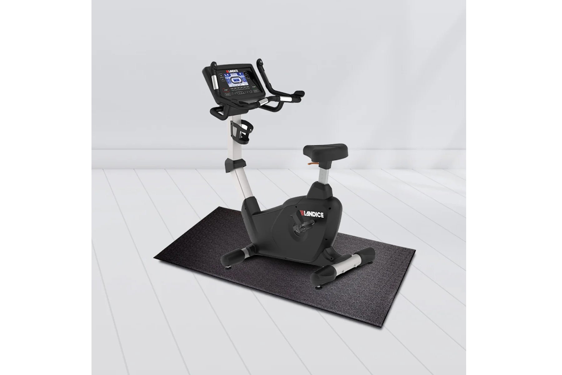 Landice U7 upright exercise bike with black and silver frame, digital display console, and black mat on white floor