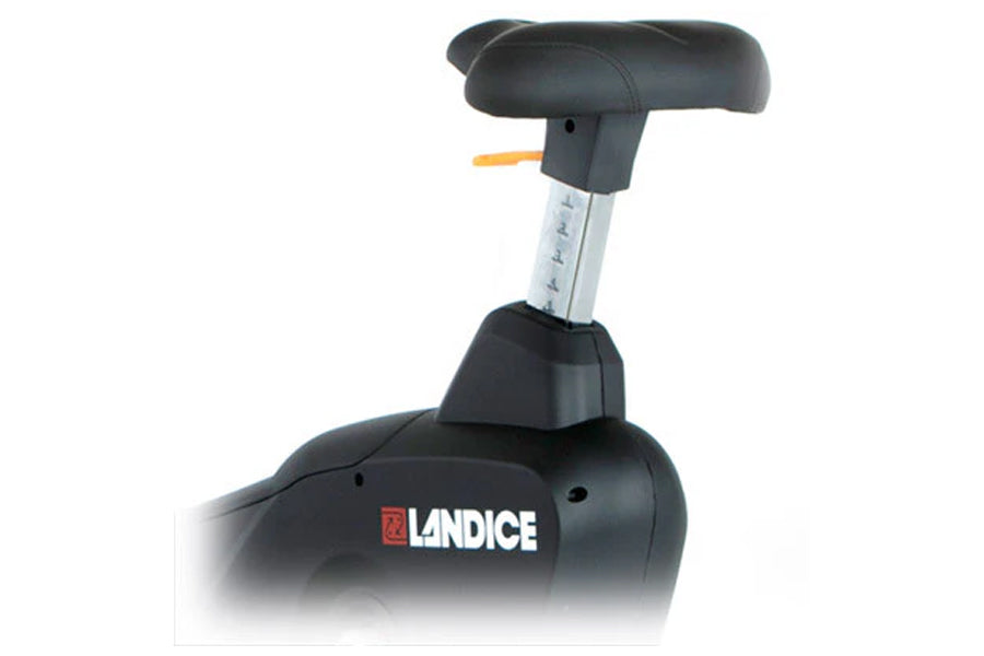 Landice U9 upright exercise bike with black padded seat and backrest, silver resistance adjustment column, and orange safety 