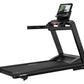 Black Life Fitness treadmill with digital display console, wide running deck, and red accent controls on white background