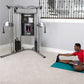 Life Fitness G7 functional trainer with dual cable towers and black control center, model demonstrating use on teal mat in ho