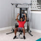 Man in red shirt using silver and black Life Fitness G7 home gym machine with cable arms raised overhead