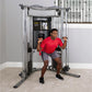 Life Fitness G7 home gym with silver frame and black console, man in red shirt using cable pulleys for exercise