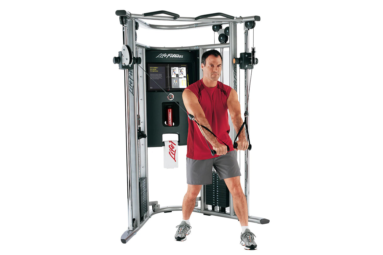 Life Fitness G7 cable machine with silver frame and black accents, model shown with male user in red tank top demonstrating c