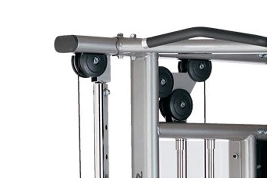 Silver and black home gym machine with pulley system, cable attachments, and adjustable weight stack