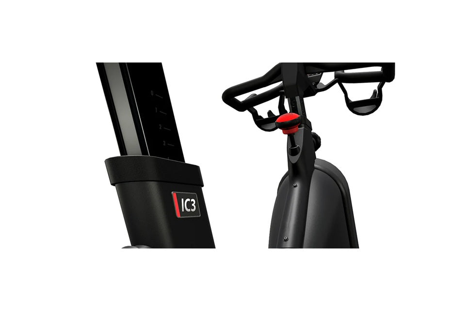 Black IC3 stationary indoor cycle with red accent on seat and handlebar, shown from side angle on white background