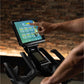 Person using a tablet on a piece of exercise equipment