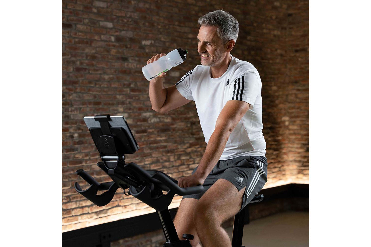 Man exercising on a stationary bike in a gym setting