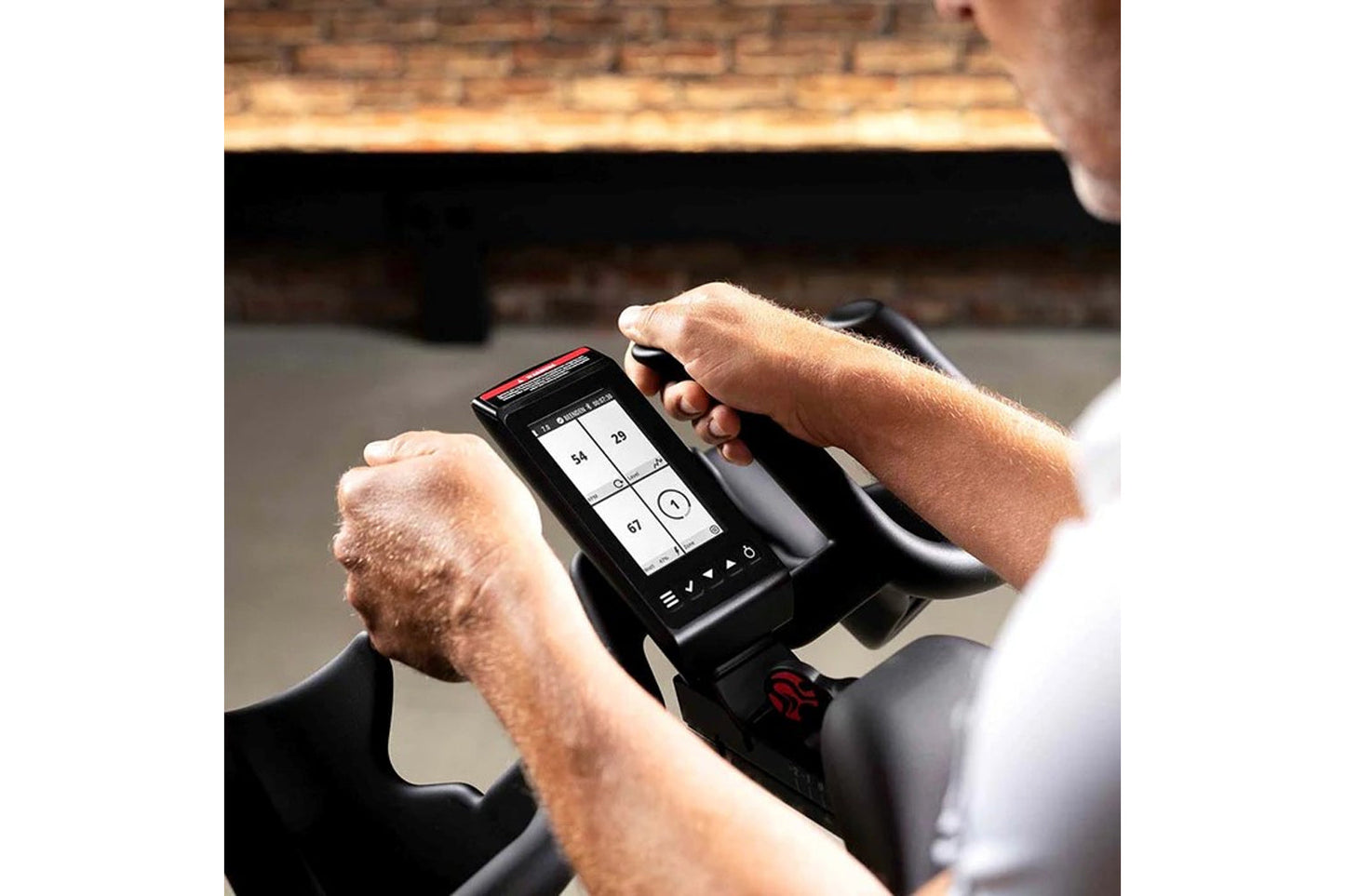 Person using a digital display on a piece of exercise equipment.