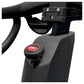 Close-up of a black exercise bike handlebar with a red 'Stop' button